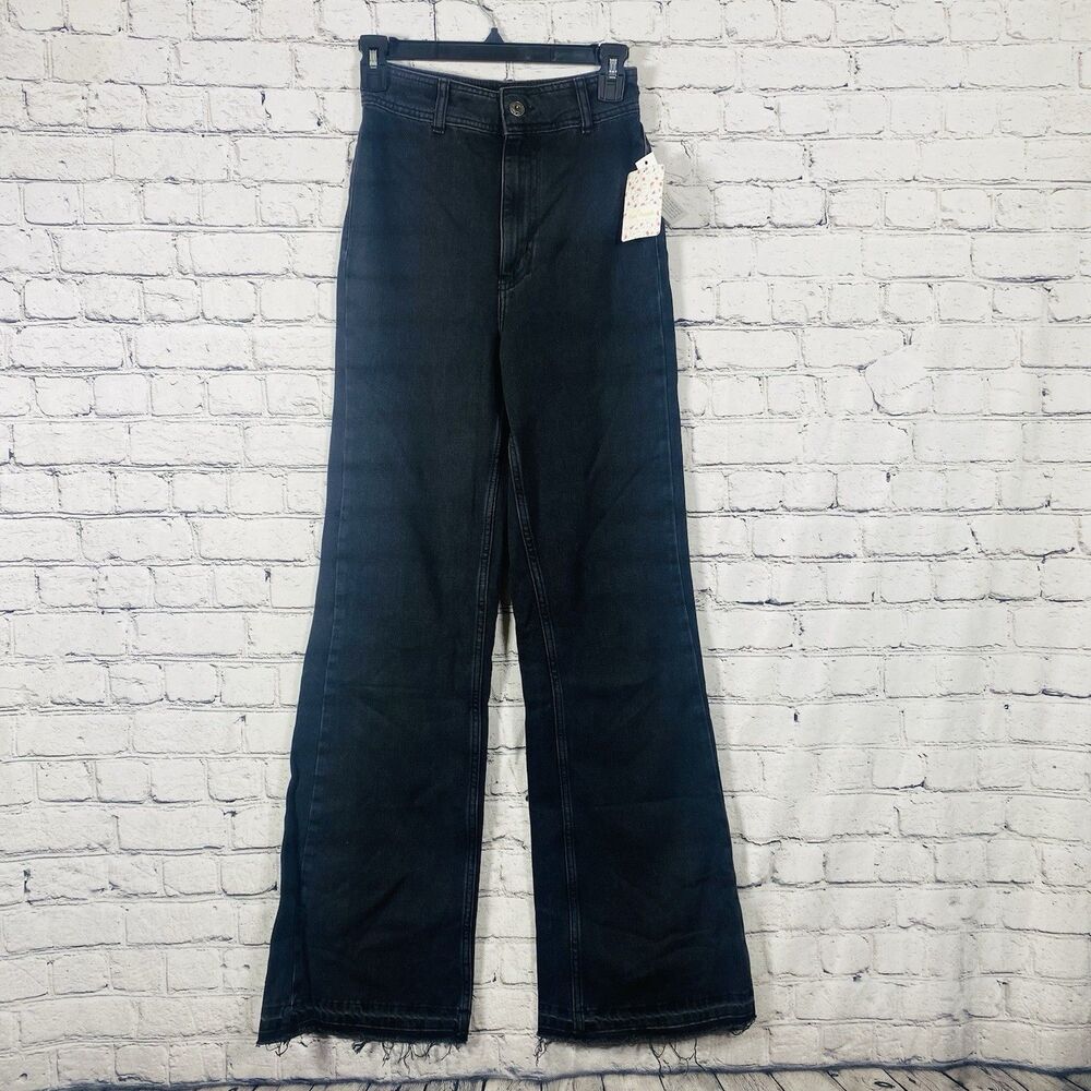 Free People black high-waisted, wide-leg jeans with a frayed or raw hem. Size 24